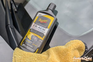Meguiar's Ultimate Black Plastic Restorer on the Venue's window trim, half applied | Image: Jason Siu / Tunerzine